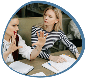 Two women engaged in a conversation about Canada's Language Proficiency Requirements for Foreign Workers.