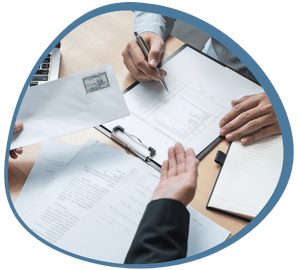 An immigration officer handing a Provincial Nominee Programs Canada Rules And Eligibility Requirements letter while the nominee fills up a form in front of him